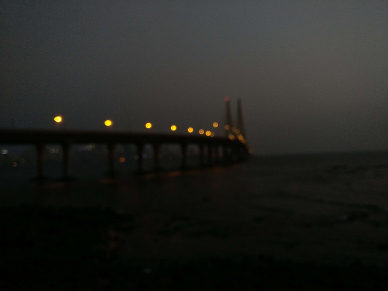 bandra, calm waters, copy space, bokeh, city, illuminated, mumbai, beach, transportation, water, no people, calm, building exterior, built structure, sea