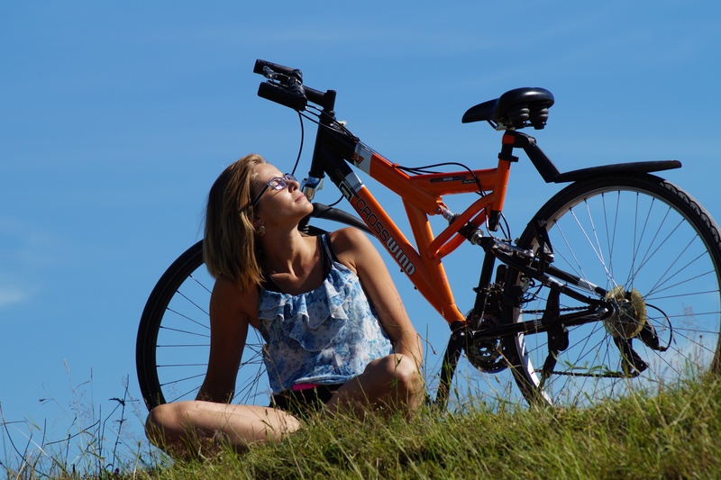 field, women, recreation, bicycle, land vehicle, grasses, peace, real people, day, sunbathing, happiness, 5K, grass, land, transportation, black, woman