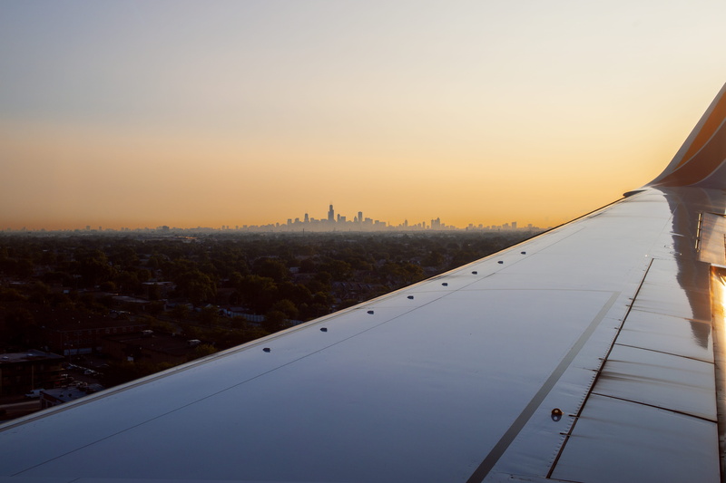 outdoors, skyline, building, sun, city, midway, building exterior, travel destinations, golden hour, plane wing, no people, urban, airplane, windy city