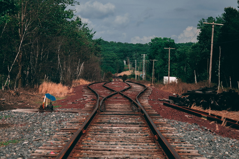 full length, diminishing perspective, engineering, brown, sky, road, railroad, one person, perspective, daylight, trees, transportation, day, vanishing point