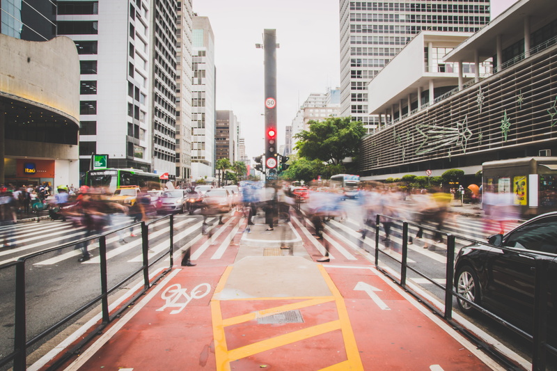 incidental people, city street, architecture, building exterior, people, outdoors, buildings, symbol, city life, modern, motor vehicle, city, traffic, sign