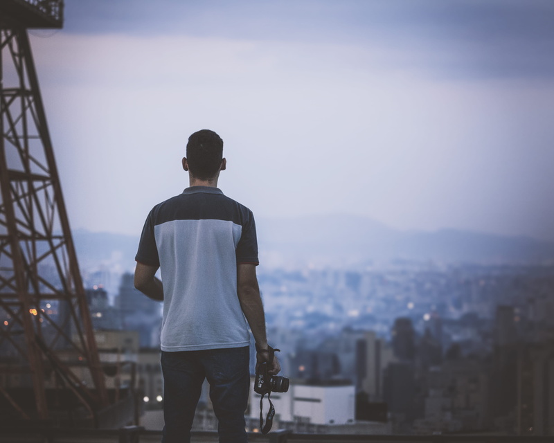 looking at view, metropolis, horizon, 4K, são paulo, nature, focus on foreground, real people, apparel, holding, black, outdoors, lifestyles, person, casual clothing