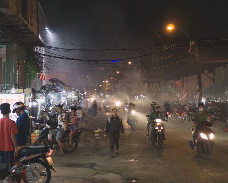 ho chi minh city, mist, lifestyles, ho chi minh, adult, men, light, vietnam, real people, lighting equipment, built structure, city, group of people, smoke - physical structure