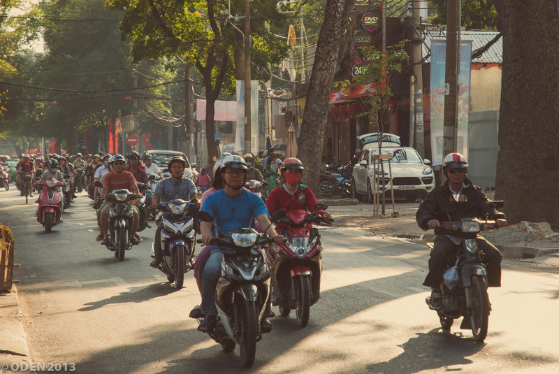 mode of transportation, lunar new year, city, adult, motorbikes, road, ho chi minh city, built structure, riding, outdoors, people, tree, building exterior