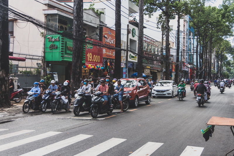 ho chi minh city, group of people, real people, asia, traffic, 5K, road marking, built structure, large group of people, motor vehicle, scooters, city life