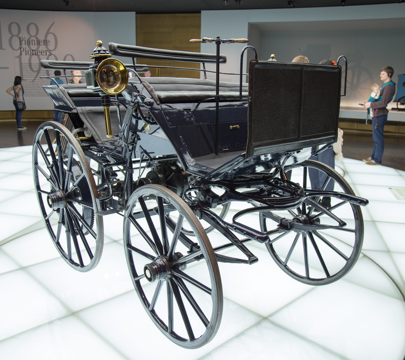 gold, shoe, wheelchair, footwear, bicycle, axle, land vehicle, wheel, wagon, human, stationary, clothing, standing, architecture, horse cart, carriage