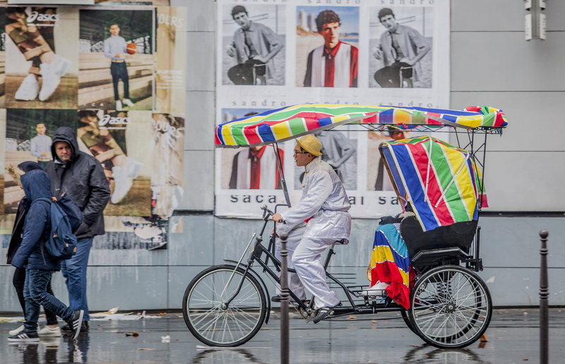 architecture, standing, day, vehicle, men, outdoors, transportation, horse cart, bicycle, city, shoe, kiosk, human, adult, riding, man, person, lifestyles