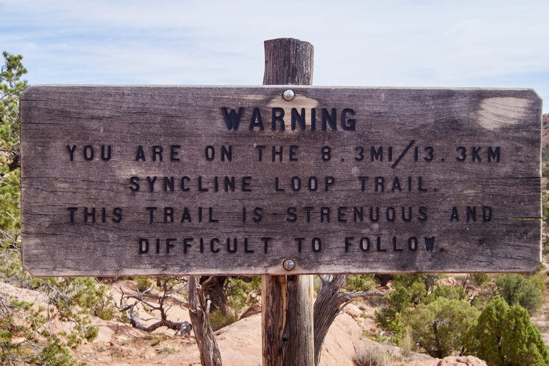 non-western script, information, close-up, script, arrow symbol, wood - material, capital letter, warning sign, sign, message, hiking, wooden post, outdoors