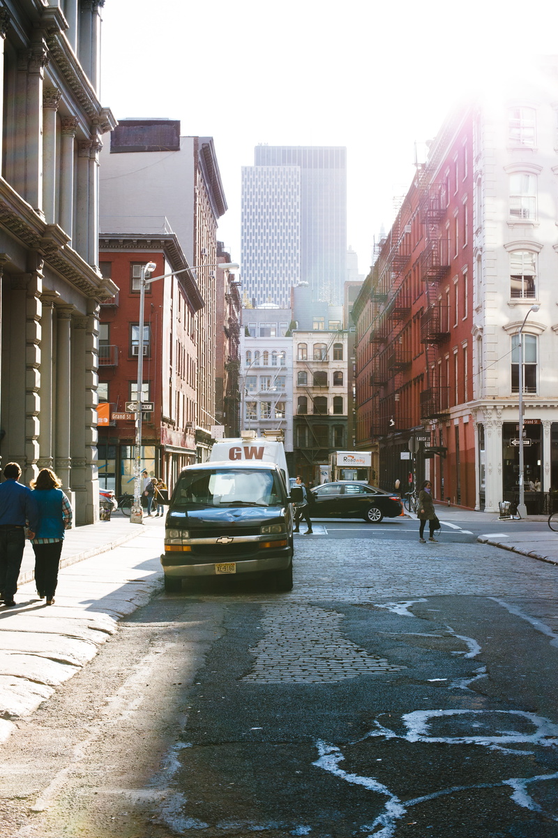 new york, soho, clear sky, car, building exterior, skyscraper, street, sky, light, city street, office building exterior, transportation, sun, architecture