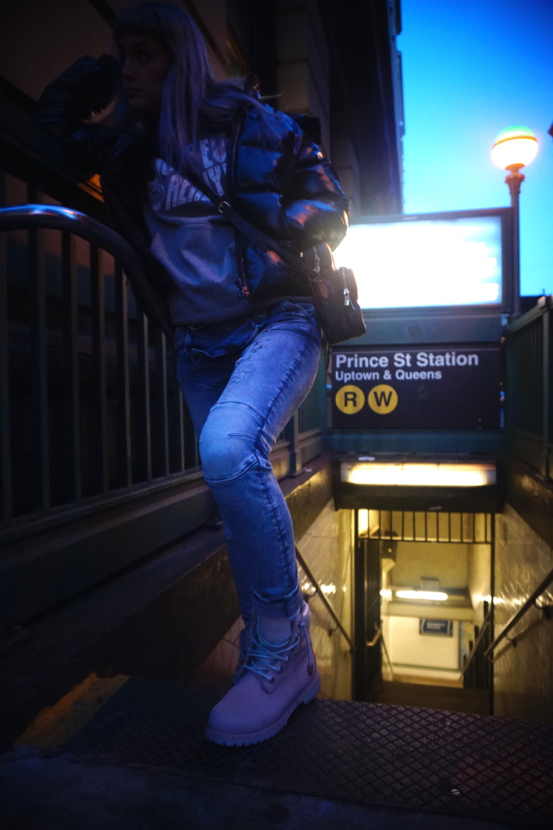 full length, 5K, one person, lighting equipment, soho, united states, jeans, night, standing, women, architecture, illuminated, railing, leisure activity