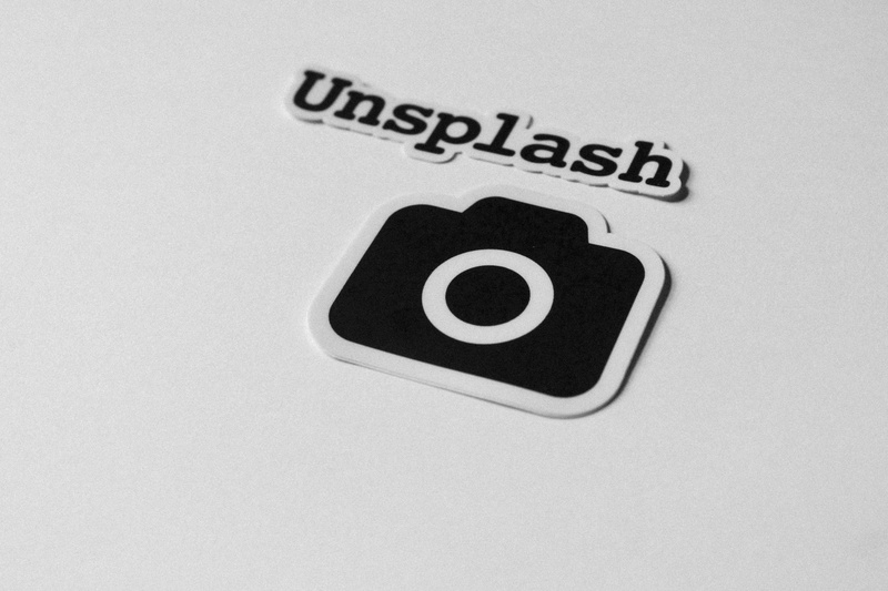 sign, paper, text, sticker, camera, indoors, still life, stickers, studio shot, no people, computer icon, cut out, connection, word, black and white, ipod