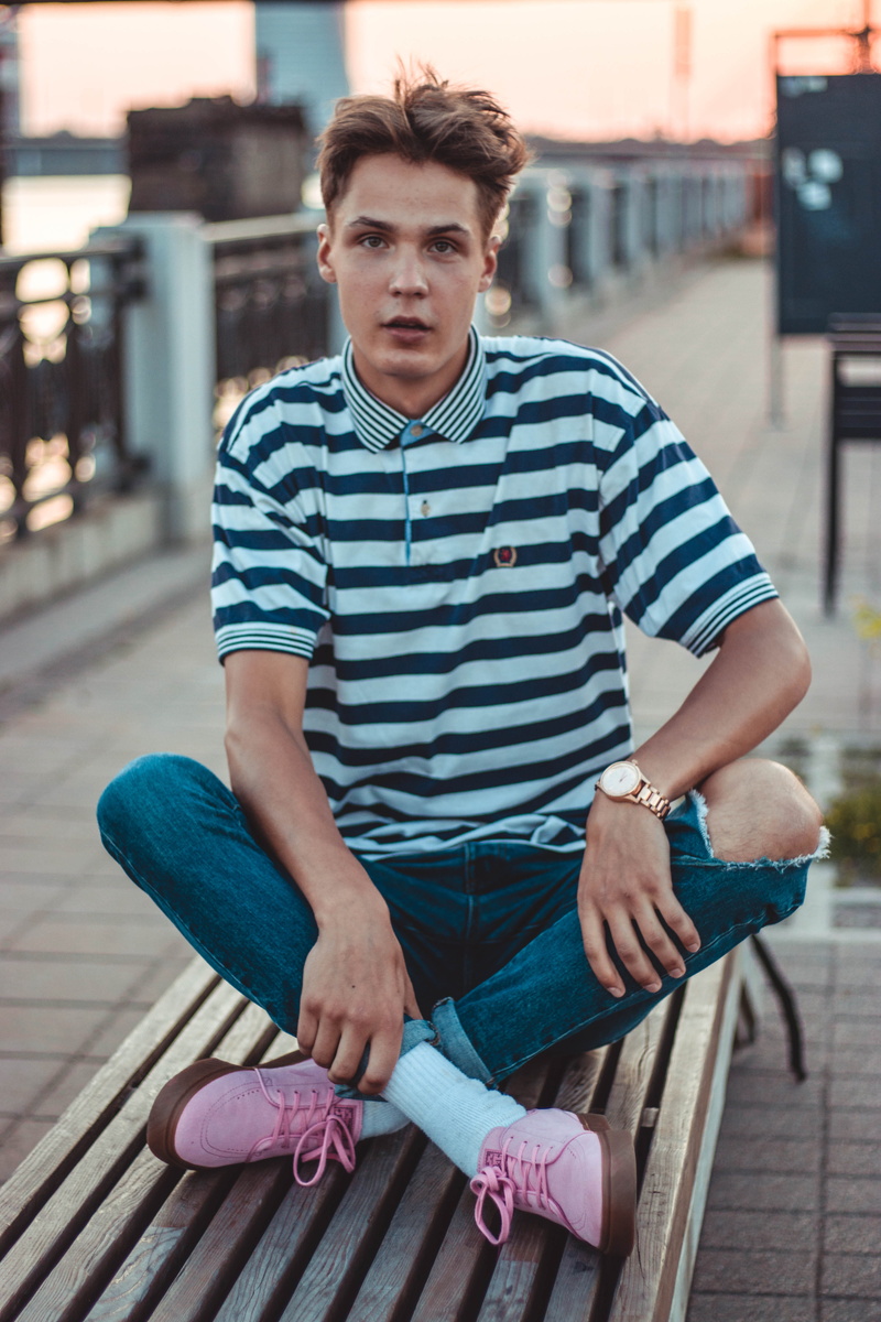 leisure activity, black, pier, casual clothing, outdoors, day, man, bench, architecture, relaxation, shirt, striped, people, real people, young adult, polo