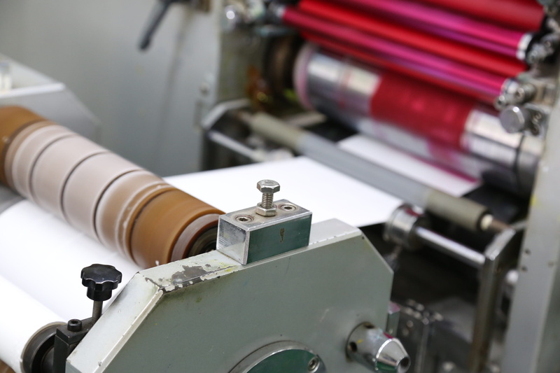 industry, bruchure printing, factory, metal industry, machine part, machinery, technology, indoors, close-up, focus on foreground, manufacturing equipment