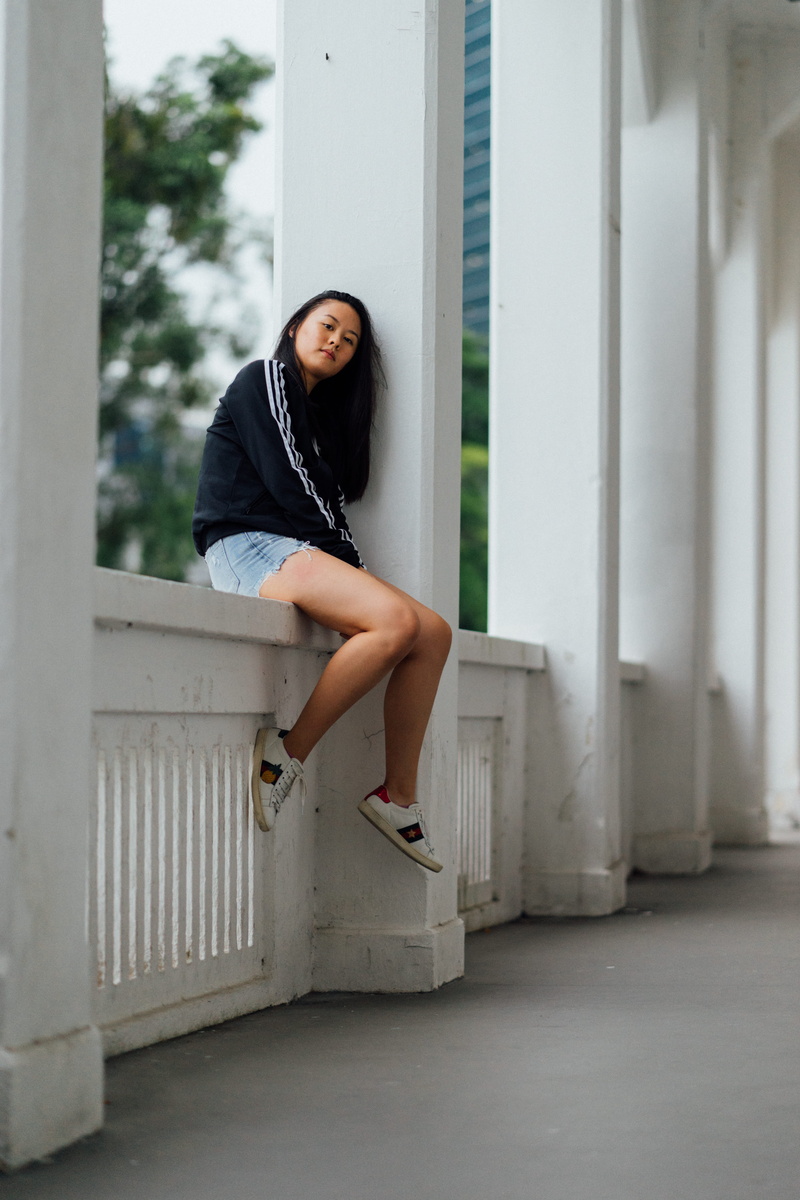 hairstyle, sit, wearing, teenager, leisure activity, lifestyles, gucci, young adult, women, girl, outdoors, sweater, asian, white, feminism, contemplation