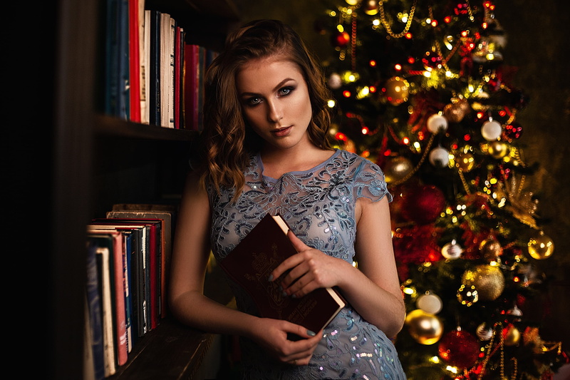 women indoors, brunette, indoors, women, Christmas, Christmas Tree, 2K, books, bookcase, depth of field, looking at viewer, model, Vlad Popov, painted nails