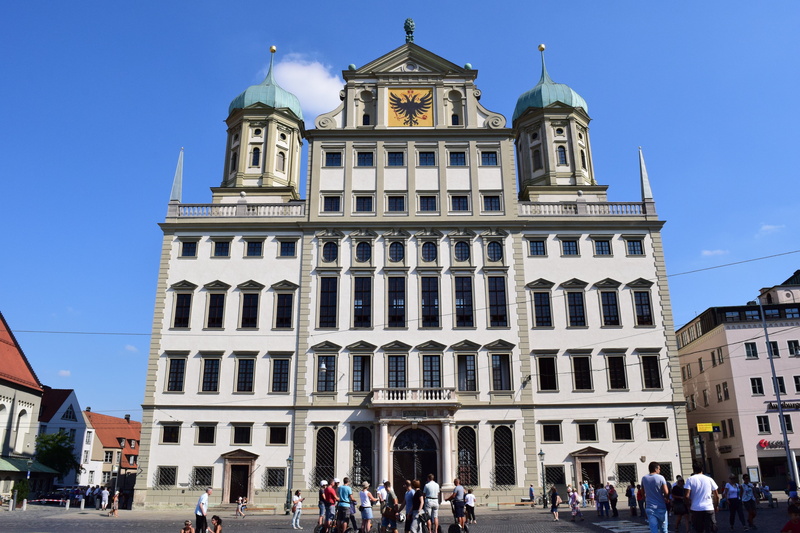 real people, city, travel destinations, crowd, history, facade, group of people, building, high building, outdoors, building exterior, town hall square