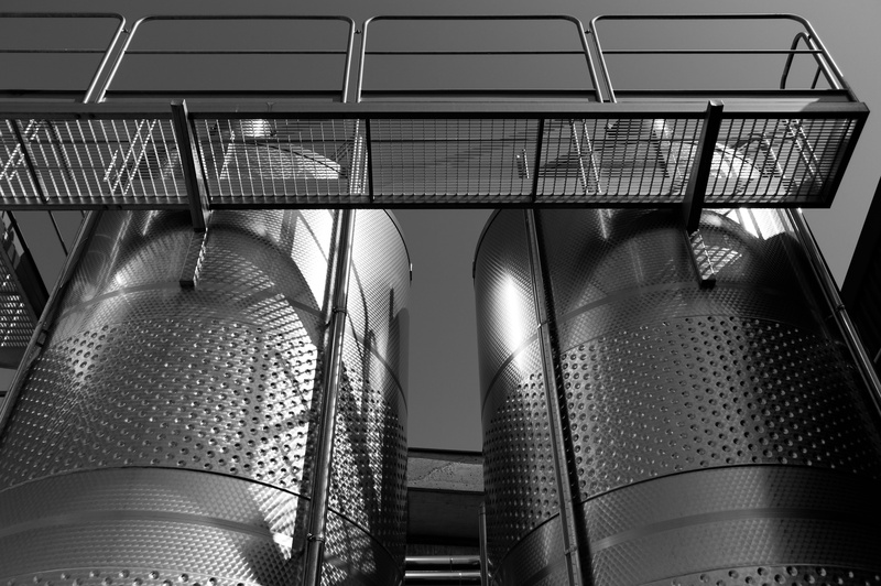 low angle view, absence, empty, ceiling, stainless steel, silver colored, winery, wine, indoors, railing, hanging, staircase, architecture, black and white