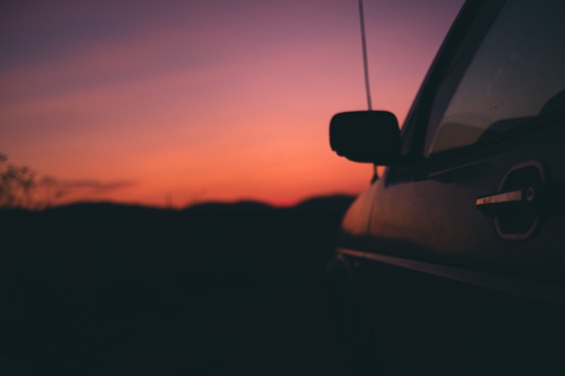 orange color, land vehicle, outdoors, on the move, car, reflection, motor vehicle, no people, orange, black, sky, window, horizon, silhouette, door, dusk