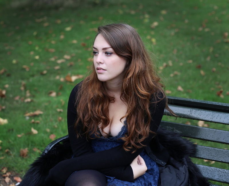 make up, Long Brown Hair, long hair, looking away, makeup, sitting, black coat, women outdoors, British, looking into the distance, black sweater, bench