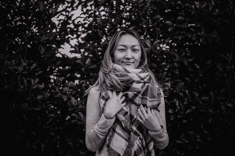 grayscale, woman, childhood, 5K, person, wearing, apparel, hairstyle, warm clothing, smiling, girls, green bush, bush, leaf, portrait, face, leisure activity
