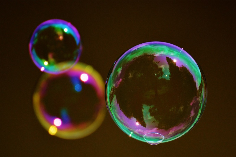 black background, soapy water, shiny, vulnerability, transparent, ball, indoors, bubble, colorful, green, nature, focus on foreground, lightweight, circle