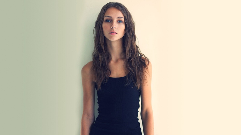 studio shot, hairstyle, long hair, adult, indoors, beautiful people, one person, fashion, young adult, women, hair, standing, blue eyes black clothing brunette long hair women rachel cook standing simple background face looking at viewer