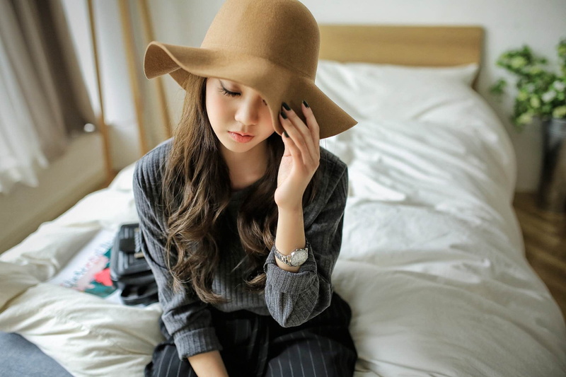 one person, furniture, brunette, hat, young adult, adult, leisure activity, long hair, millinery, bedroom, women, casual clothing, hairstyle, young women