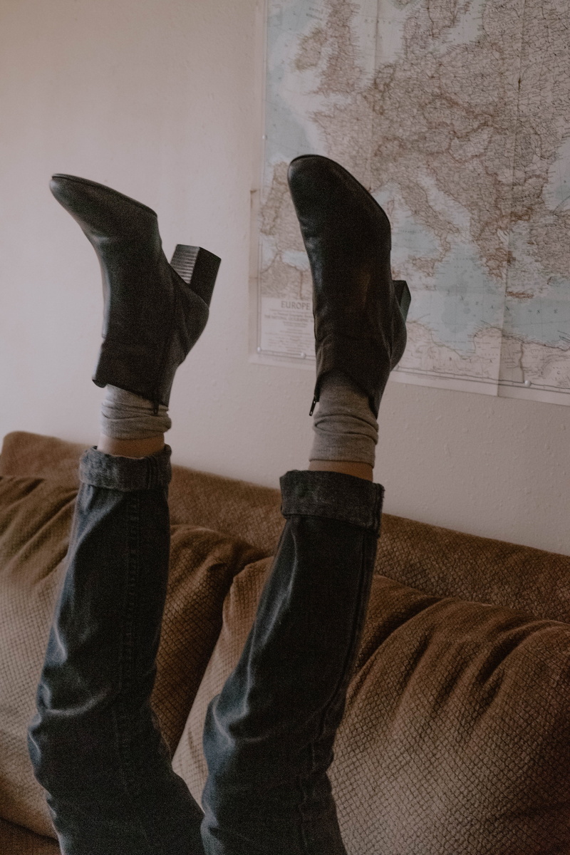 sock, boots, low section, ankle, pair, indoors, human foot, furniture, real people, wall - building feature, casual clothing, feet up, air, person, leisure activity