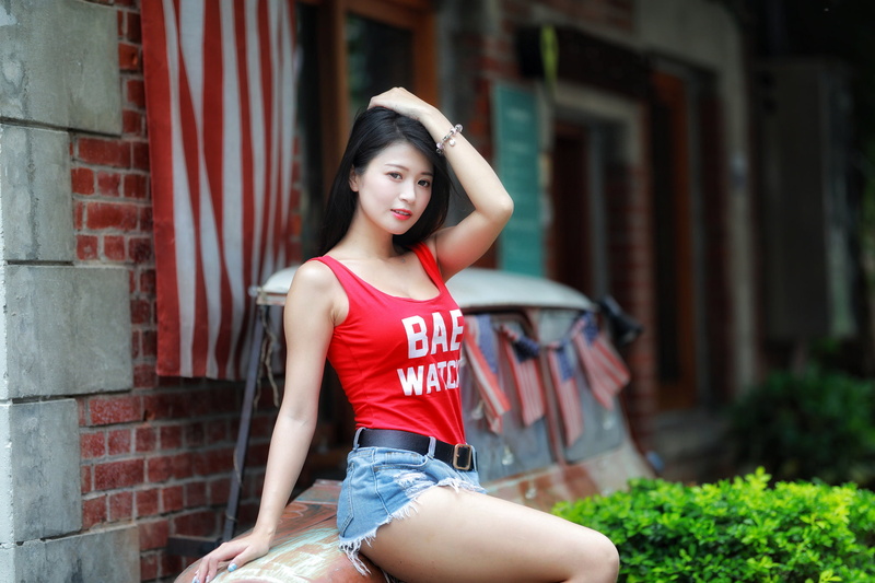 model, American flag, women outdoors, sitting, Asian, women, tank top, Lin Jiayi, 1080P, portrait, Stars and Stripes, hands on head, jean shorts, brunette