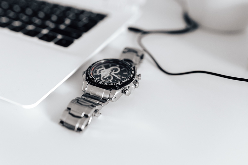 desk, high angle view, keyboard, connection, indoors, global communications, wireless technology, watch, silver watch, computer keyboard, workspace, two objects