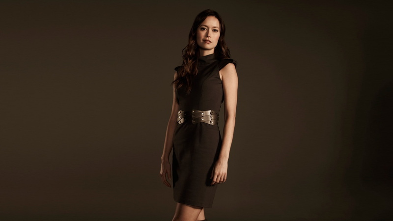 indoors, actress, fashion, contemplation, adult, women, black background, mini skirt, brown hair, glamour, three quarter length, one person, hairstyle