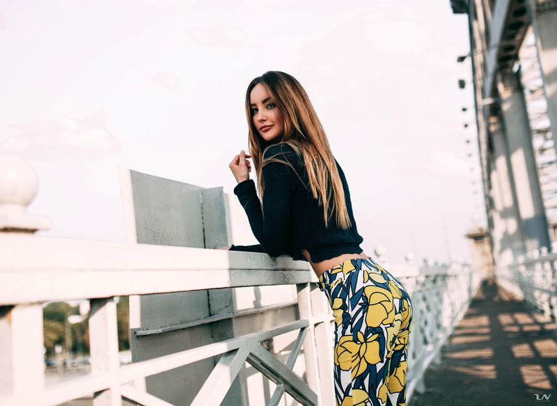 portrait, women outdoors, smiling, depth of field, 2K, blonde, women, pants, looking over shoulder