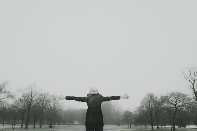 real people, winter, leisure activity, day, woman, snow, view, standing, grey, front view, surrounded, arms outstretched, women, bare tree, cold, trees