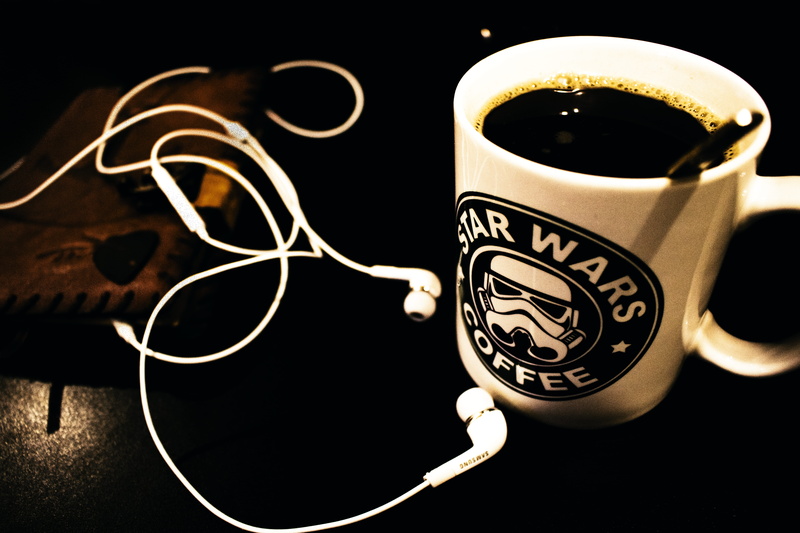 star, headphones, two objects, focus on foreground, food and drink, buds, black background, canal, cup, liquid, black, crockery, symbol, breakfast, no people