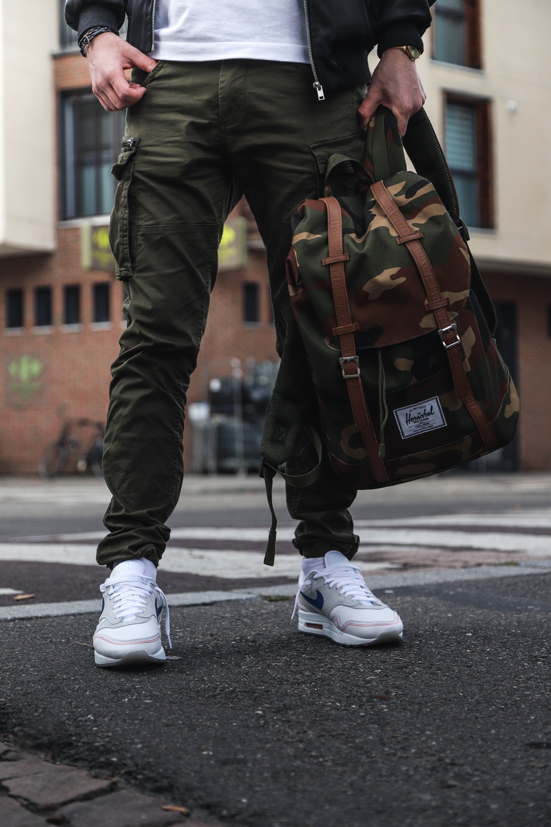 outdoors, walking, clothes, city Life, building, holding, adult, menswear, 5K, bicycle, mens fashion, herschel bag, people, young Adult, person, sport