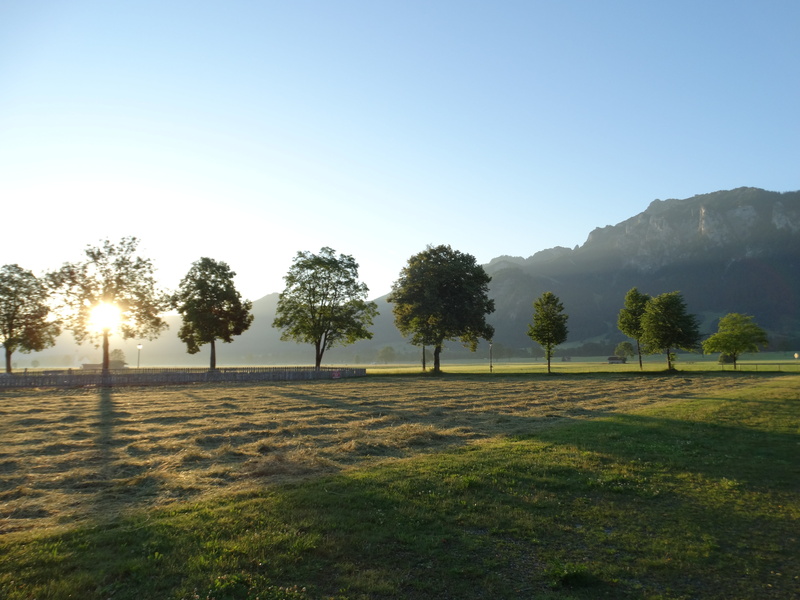 sunrise, grass, land, blue sky, clear sky, alpine, green color, landscape, scenics - nature, outdoors, beauty in nature, day, field, nature, sky, no people