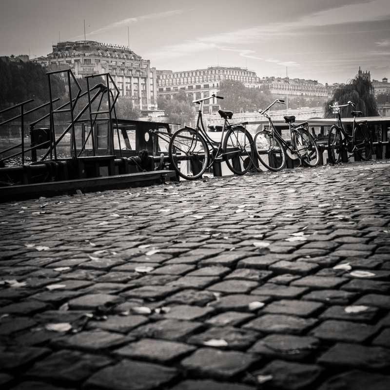 city, sky, two, cobblestone, no people, three, bridge - man made structure, outdoors, gray, bikes, near, parked, nature, transportation, town, dock, mode of transportation
