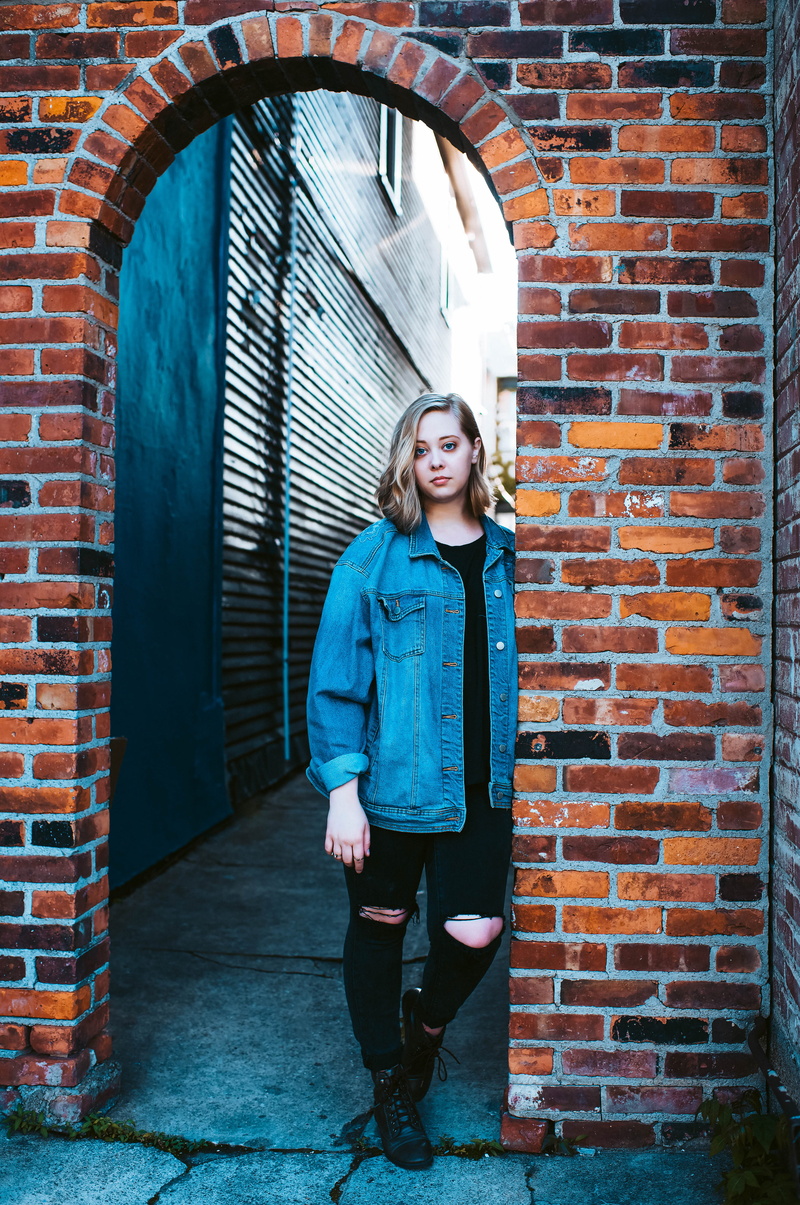 architecture, standing, leisure activity, wall - building feature, city, woman, person, buffalo, people, united states, looking at camera, casual clothing