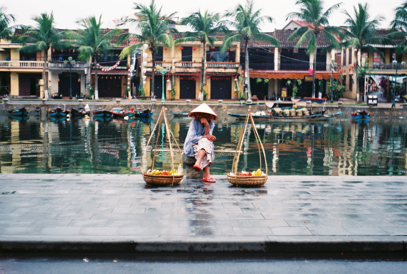 tropical climate, waterfront, person, nature, plant, 35mm, adult, sitting, vehicle, watercraft, human, one person, mode of transportation, building, architecture