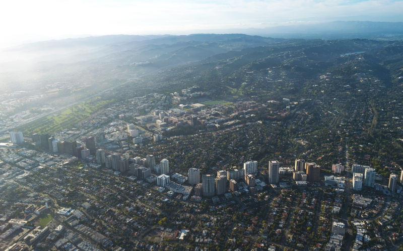 green, office building exterior, urban, day, high angle view, crowded, mountain, building exterior, beverly, residential district, environment, street