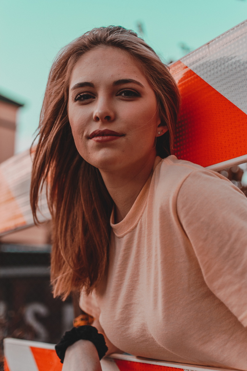 looking at camera, leisure activities, beautiful woman, one person, person, hair, human, apparel, wood, finger, lip, girl, seat, day, head, wearing, female