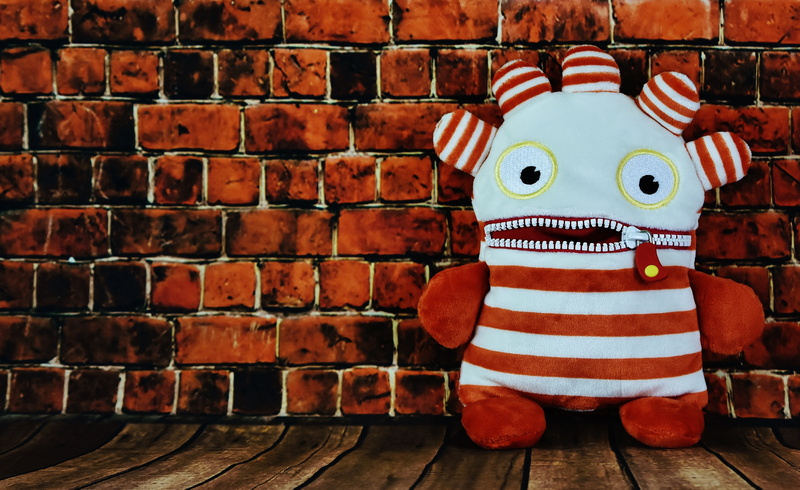 brick, human representation, 5K, ensure püppchen, obscured face, brick wall, toy, day, red, funny, indoors, humor, wall - building feature, architecture