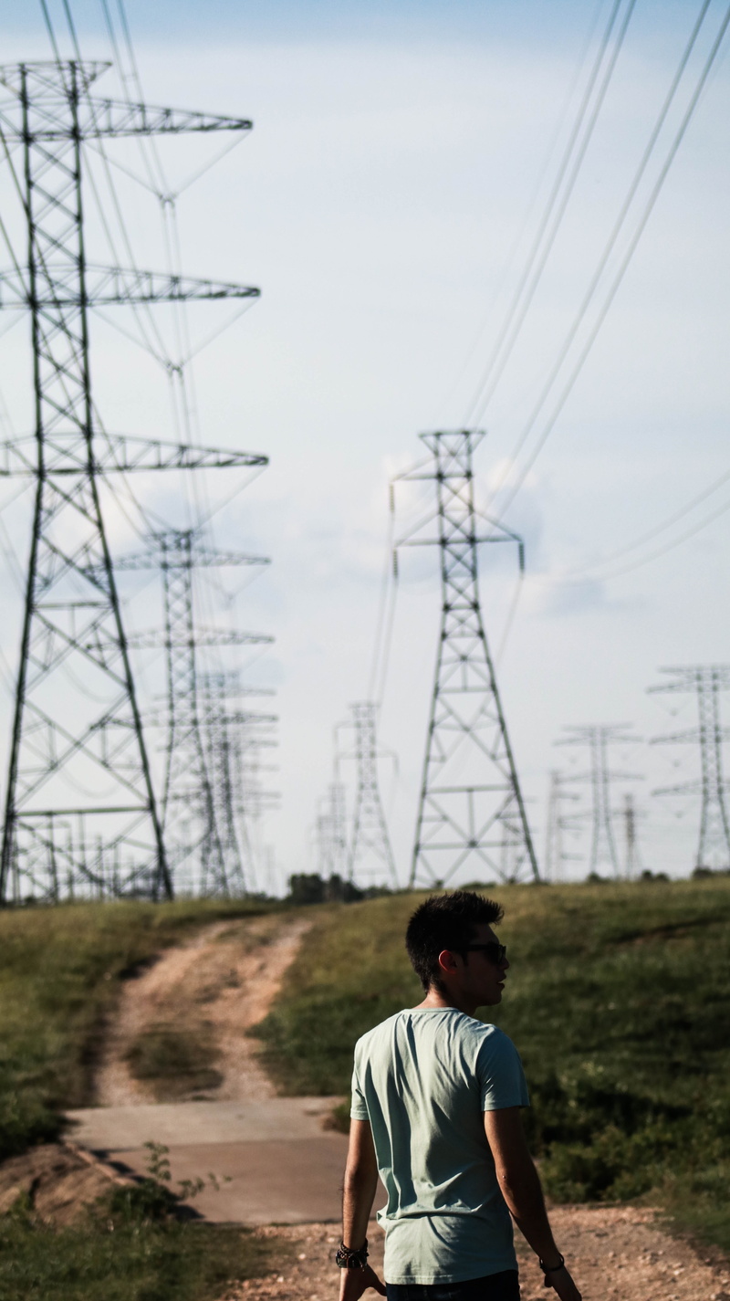 real people, focus on foreground, shades, lifestyles, nature, sugar land, men, technology, electricity pylon, day, outdoors, connection, people, power line