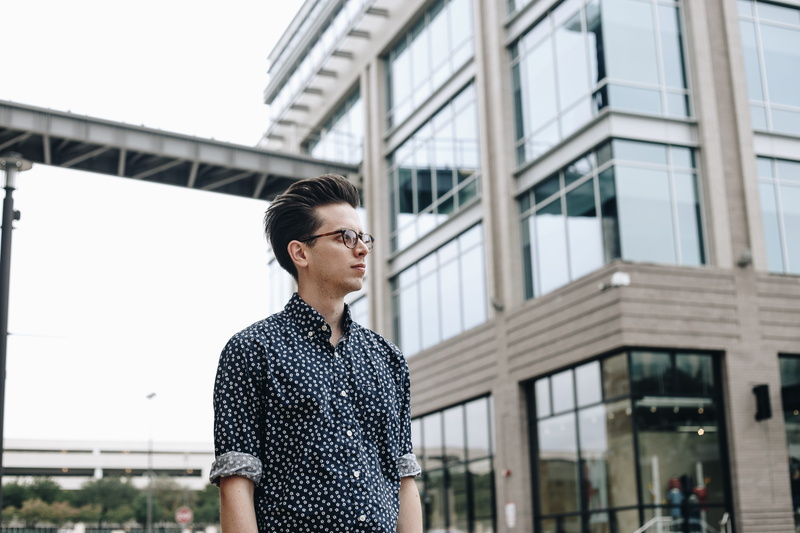 one person, front view, casual clothing, focus on foreground, face, black, housing, young men, female, portrait, building, oven, people, high rise, focus