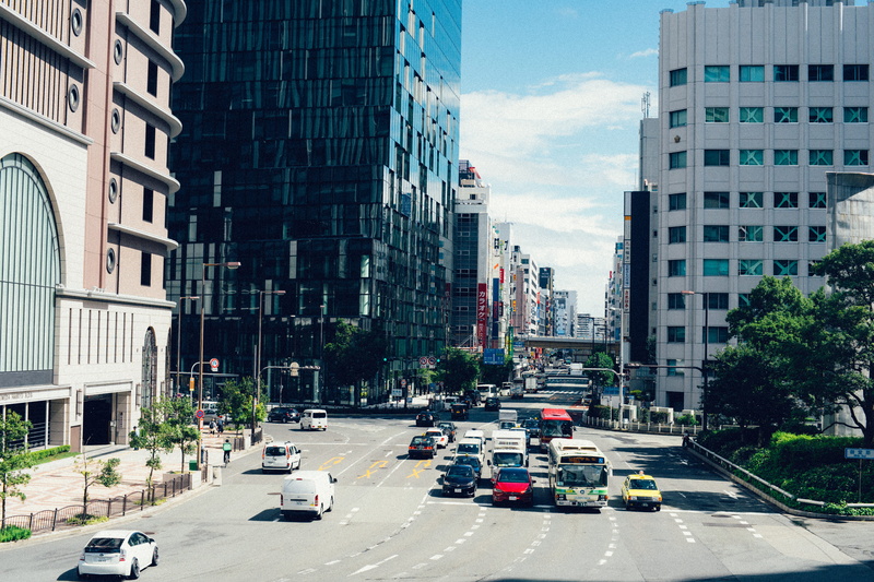 incidental people, tarmac, land vehicle, car, roadway, street photography, office building exterior, road, motor vehicle, traffic, vehicles, nature, osaka