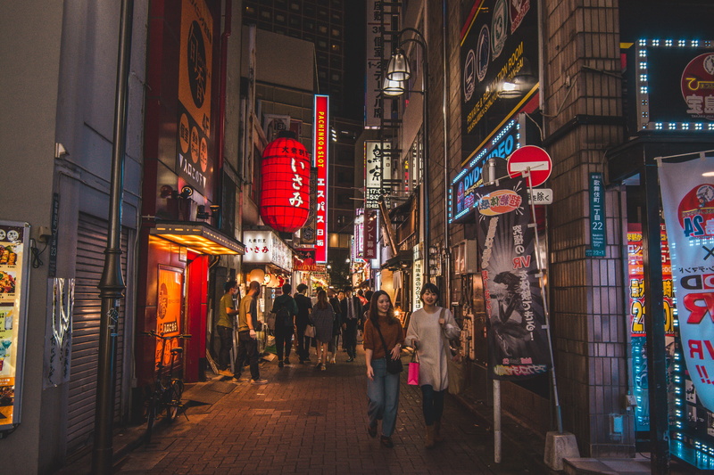 walking, people, alleyway, night life, pathway, pavement, architecture, communication, town, store sign, metropolis, text, city, city life, illuminated