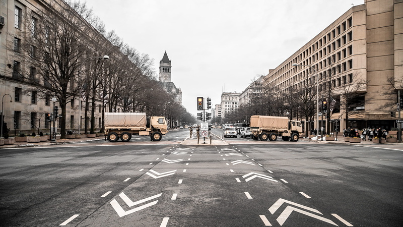 street, traffic light, asphalt, light, building exterior, diminishing perspective, urban, machine, building, incidental people, road, person, built structure