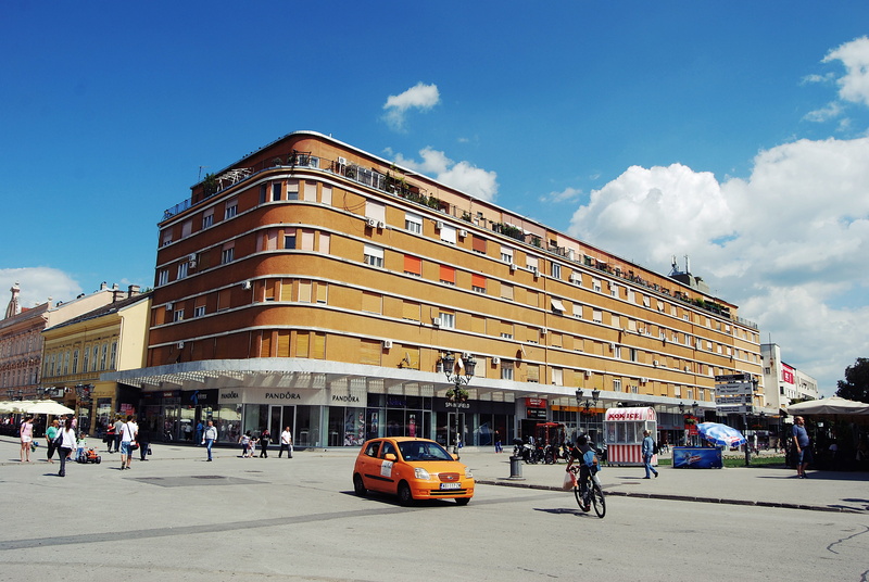 office building exterior, cloud - sky, editorial, car, city Life, road, building Exterior, brown, group of people, urban Scene, crowd, daytime, built Structure