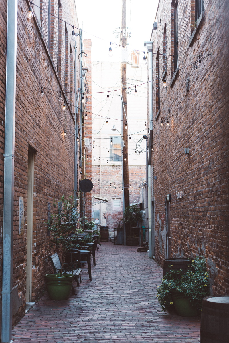 windows, buildings, no people, urban, pots, potted plant, direction, day, narrow, building exterior, street, the way forward, cobblestones, walls, residential district
