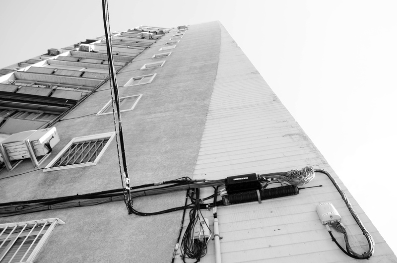 city, outdoors, skycrapper, tower, window, house, clear sky, barrio, sky, bw, power supply, building exterior, low angle view, wall - building feature